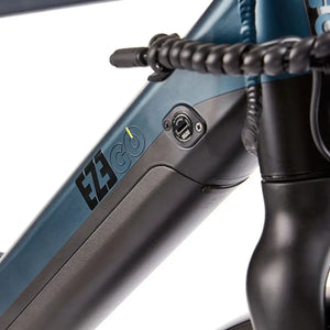 Close-up of the EZEGO Commute Int's gents battery seamlessly integrated into the downtube, featuring a security lock and LED charge level indicator.