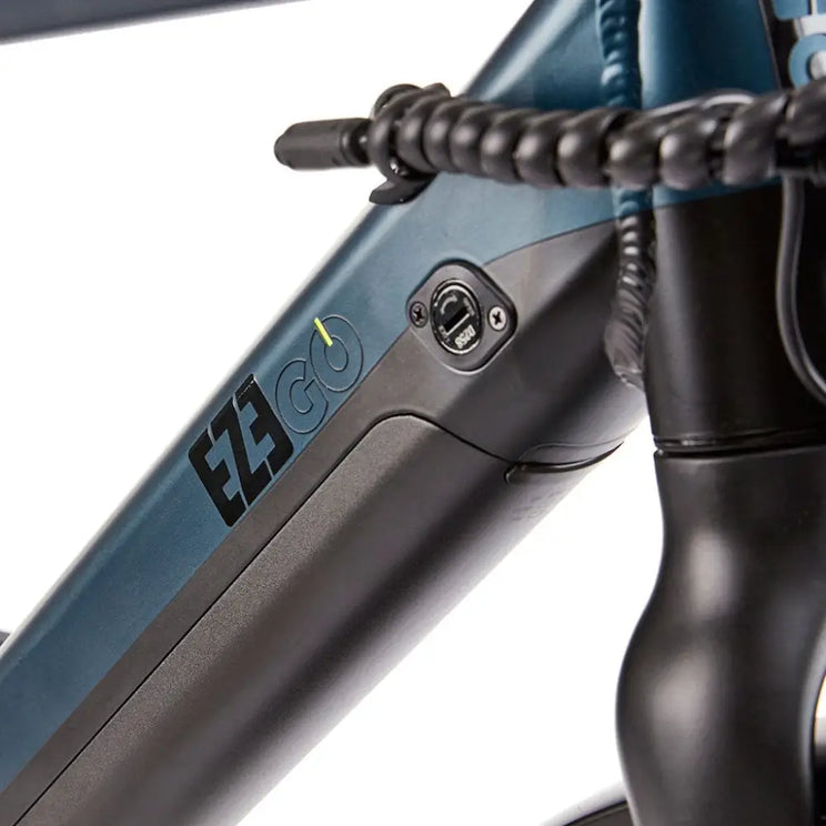Close-up of the EZEGO Commute Int's gents battery seamlessly integrated into the downtube, featuring a security lock and LED charge level indicator.