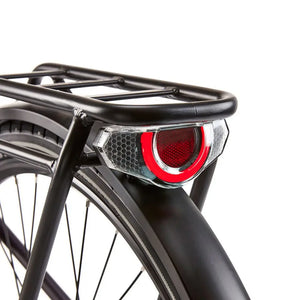 Close-up of the bright red rear LED light integrated into the pannier rack of the EZEGO Commute Int Gents, ensuring high visibility and safety for urban riding.