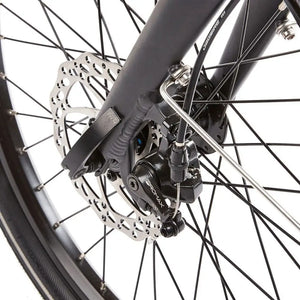 Close-up detail of the Promax mechanical disc brake caliper on the front wheel of the EZEGO Fold electric bike ensuring safe stopping power.