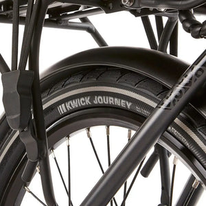 Close-up of the Kenda Kwick Journey tire tread and reflective sidewall on the EZEGO Fold electric bike wheel.