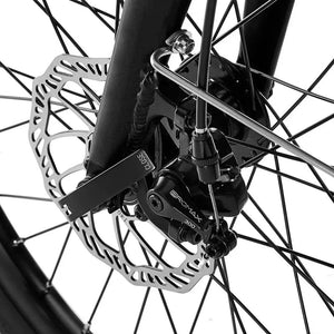 Close-up detail of the Promax mechanical disc brake caliper on the front wheel of the EZEGO Fold electric bike.