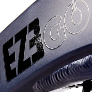 Close-up of the embossed EZEGO logo branding on the dark grey frame of the Step NX electric bike.