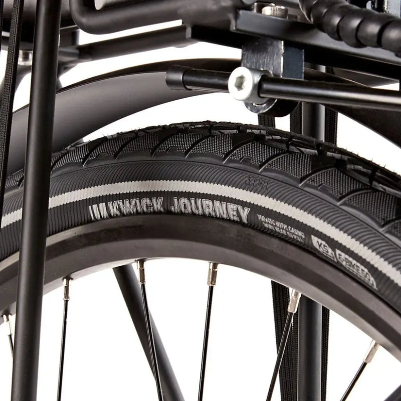 Close-up of the Kenda Kwick Journey tire tread and reflective sidewall strip on the EZEGO Step NX wheel.