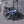 Falcon Compact electric folding bike 250W folded and parked outdoors against a brick wall, highlighting compact storage for city use.