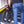 Falcon Compact electric folding bike 250W being carried upstairs in folded position, demonstrating portability and compact design.