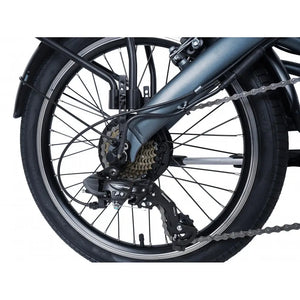 Close-up of the Falcon Compact electric folding bike's rear wheel, gears, and derailleur system.