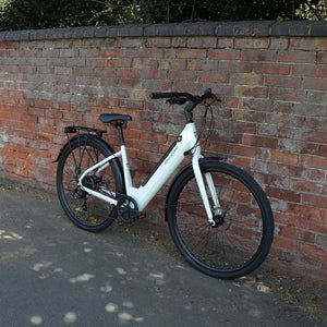 The Falcon Liberty electric bike parked against a brick wall, illustrating its stylish low-step design suitable for urban commuting, shopping runs, and leisure rides.