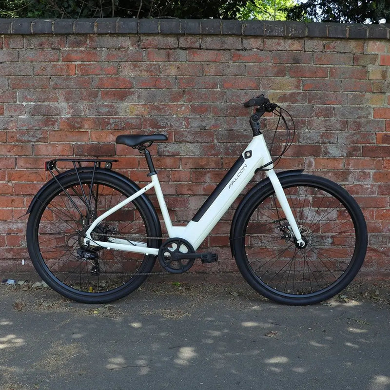 The Falcon Liberty electric bike parked against a brick wall, illustrating its stylish low-step design suitable for urban commuting, shopping runs, and leisure rides.