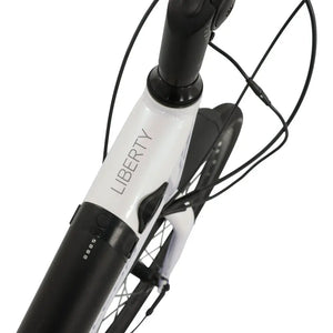 Detail shot of the white top tube on the Falcon Liberty electric bike, featuring the minimalist "Liberty" model branding and clean weld finishes.