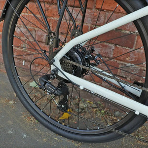 Close-up of the Falcon Liberty drivetrain showing the 7-speed Shimano Tourney rear derailleur and gear cassette, designed for reliable shifting on city streets.