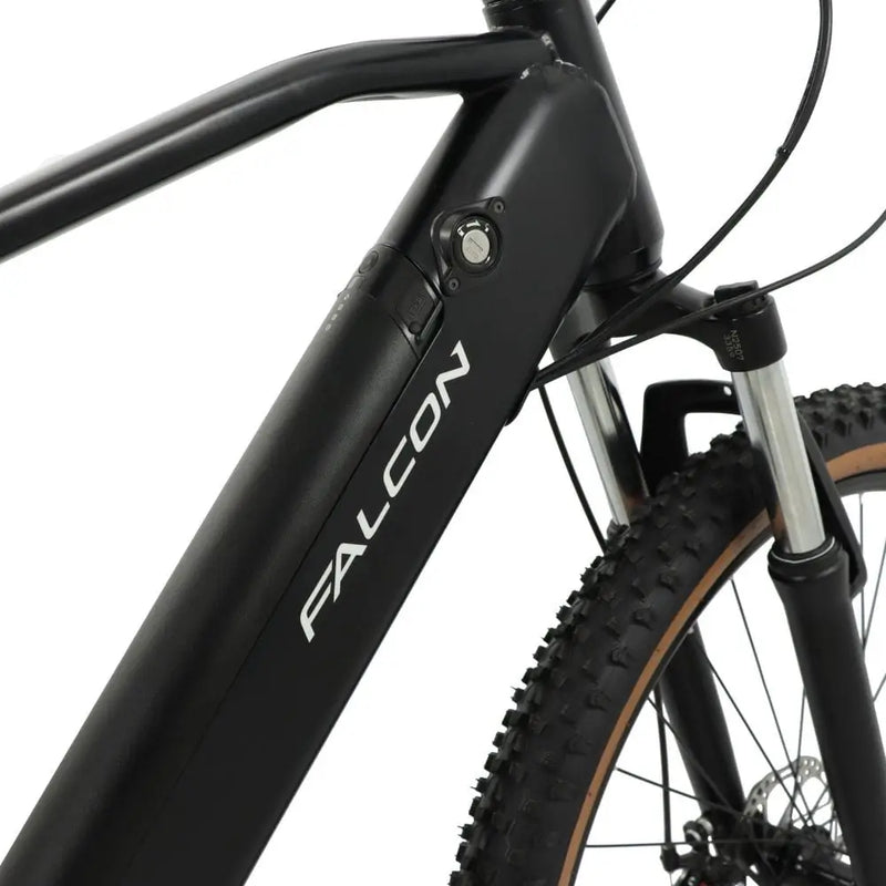 Detail view of the Falcon Turbine's downtube, highlighting the sleek integrated 36V battery design with the Falcon logo and security key lock mechanism.