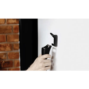Hand mounting the Hiplok Home Gold chain lock onto a secure wall hook, ideal for indoor bike storage.