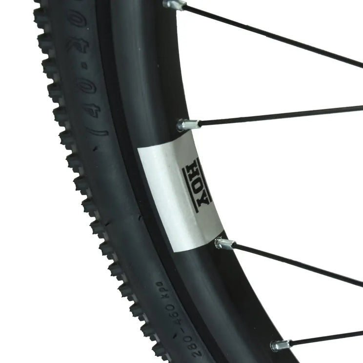 Extreme close-up of the tire tread pattern and HOY branded rim on the 20-inch wheel of the Pentland kids' bike.