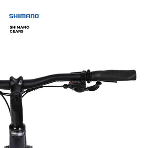 Close-up of the Shimano 7-speed gear shifter mounted on the handlebars of the Hygge Aarhus electric bike.