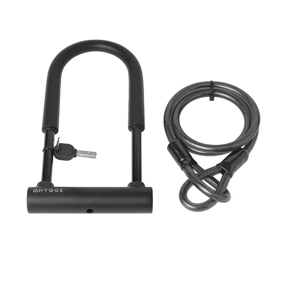 Flat lay of the Hygge D-Lock set with keys and cable alongside the original box, offering full bike security.