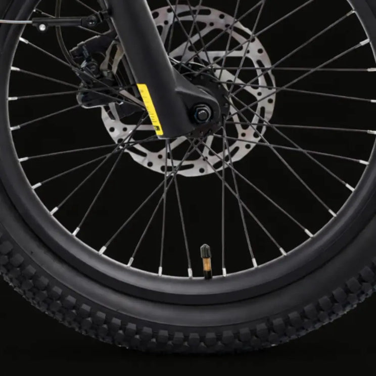 Hygge Herlev electric bike front wheel with disc brake and tyre tread for urban commuting.