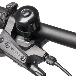 Close-up of the Shimano shifter, Tektro hydraulic brake lever and bell on the Hygge Lossø handlebar.