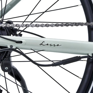 Close-up of Hygge Lossø electric bike chainstay and internal cable routing with chain and frame detail.