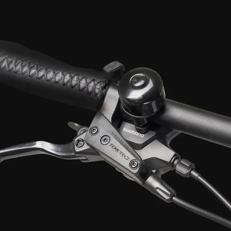 Close-up of the handlebar, bell, and brake lever on the Hygge Lossø Commuter Hybrid Electric Bike 250W.