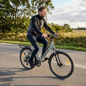 Rider using Hygge Lossø step-through electric bike 250W on a road showing comfortable urban commuting position.