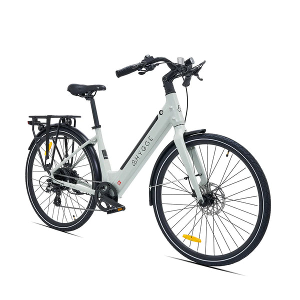 Slanted front angled view of the Hygge Nivø e-bike, showing the integrated lights and front wheel.