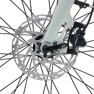 Close-up of the front wheel and Tektro hydraulic disc brake on the Hygge Nivø e-bike.