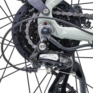 A close-up of the rear wheel, cassette, and Shimano Altus derailleur on the Hygge Nivø bike.