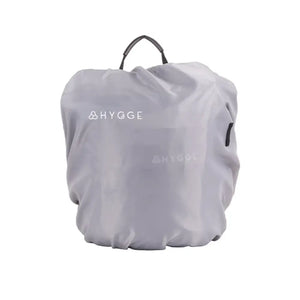 A Hygge pannier bag covered by a grey waterproof rain cover to protect contents during wet weather.