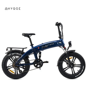 Full side profile of the Hygge Sorø 2025 Foldable Electric Bike in metallic blue, showing the robust frame and 20-inch fat tyres.