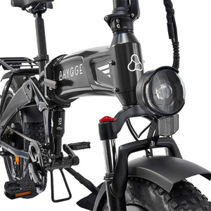 The black Hygge Sorø electric bike front suspension fork with integrated LED headlight for improved comfort and visibility.