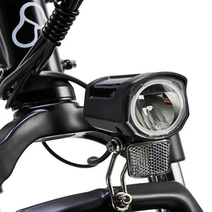 Close-up of Hygge Vester electric bike front LED light and reflector for enhanced visibility and safety.