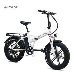 Studio side profile of the white Hygge Vester 2025 folding electric bike, featuring 20-inch fat tyres and a step-over frame.