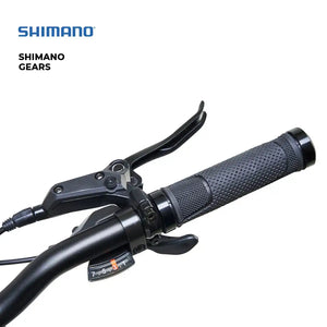 Detail shot of the Shimano gear shifter and ergonomic handlebar grips on the Hygge Vester folding electric bike.