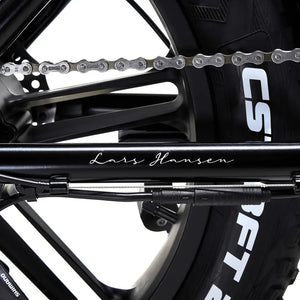 Close-up of the 'Lars Hansen' signature decal on the chainstay of the Hygge Vester Step electric bike.