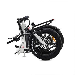 The white Hygge Vester Step electric bike in its fully folded position, demonstrating its compact size for storage.