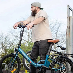 Tall rider standing with Hygge Virum step through electric bike demonstrating frame accessibility and size suitability.
