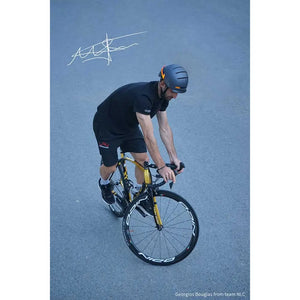 Cyclist wearing the Livall BH51M Neo smart helmet while riding a road bike, showcasing aerodynamic design and LED safety lights.