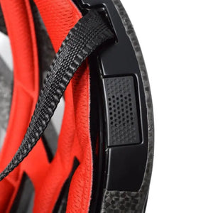 Close-up of the interior padding and strap attachment of the Livall BH60SE smart cycle helmet, showing the red cushioning and black safety strap.