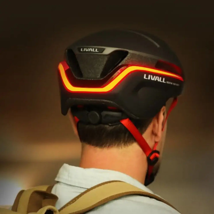 Rear view of the Livall EVO21 smart cycling helmet in black, showing bright LED light strip for enhanced night visibility.