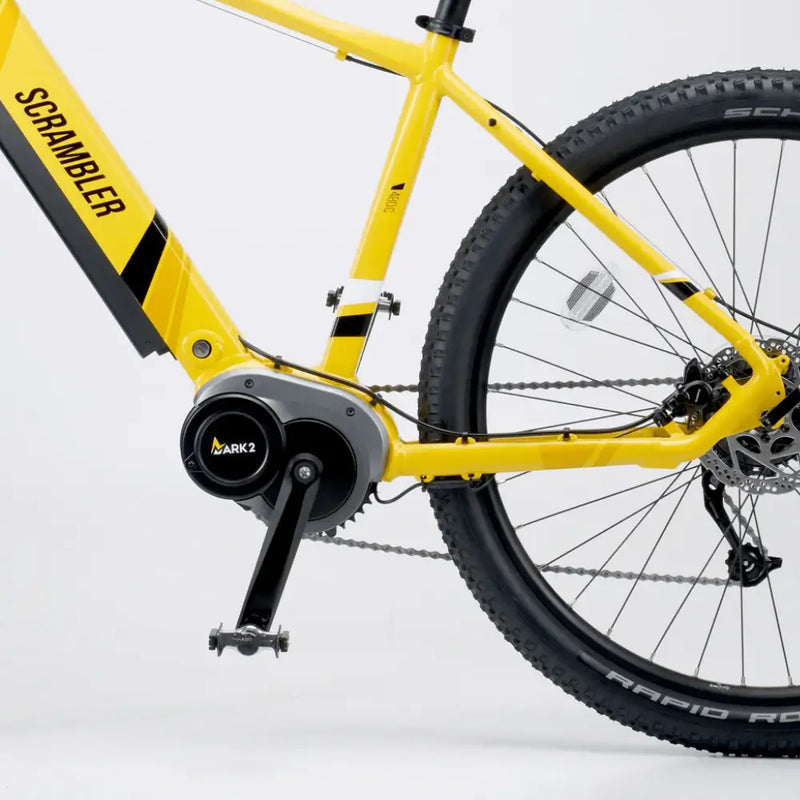 Close-up of the Mark2 Scrambler C electric bike frame in yellow, showing the high-torque 250W Promovec mid-drive motor and crank system.
