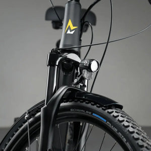 Close-up detail of the Mark2 Scrambler CX front end, featuring a bright LED headlight and protective mudguard for safety and cleanliness.