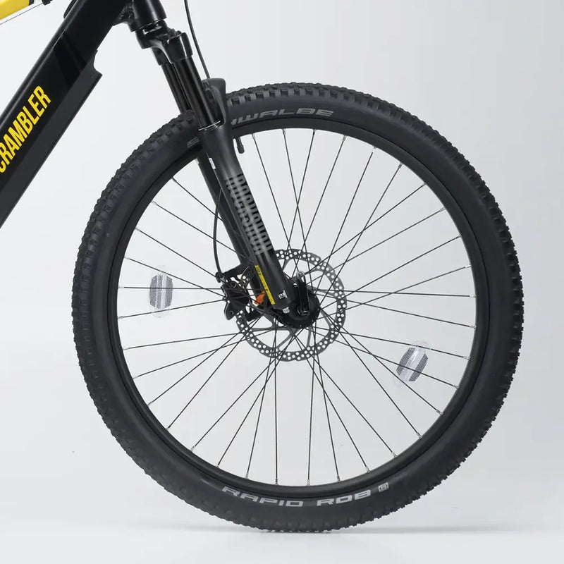 Close-up of the Mark2 Scrambler's front wheel, featuring hydraulic disc brakes and Schwalbe Rapid Rob tyres for superior grip.