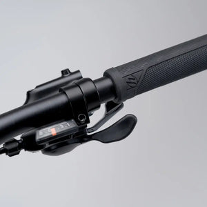 Detailed macro shot of the ergonomic handlebar grip and Shimano gear shifter on the Mark2 Scrambler electric bike.