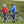 A couple in winter jackets standing next to their Mark2 X-Cross 520 e-bikes on a grassy hill.