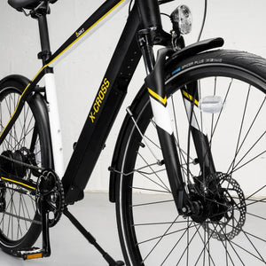 Detail view of the front suspension fork, mudguard mount, and integrated LED headlight.