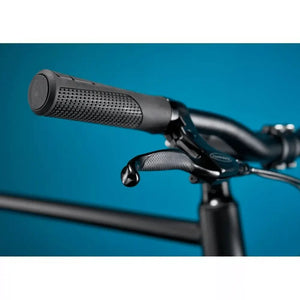 Close-up of the textured ergonomic handlebar grips and brake lever on the Pure Flux One electric bike.