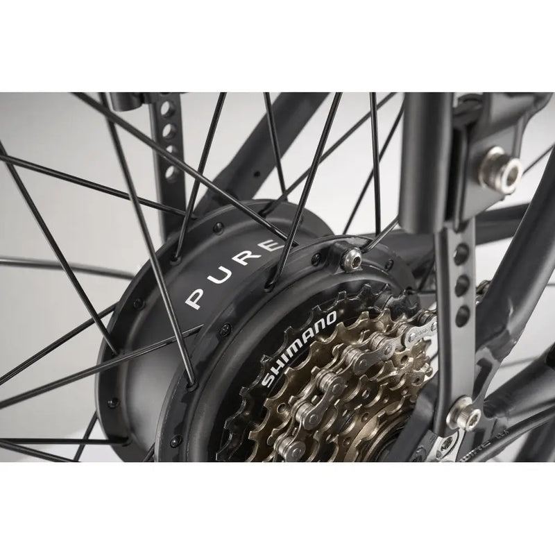 Detail view of the 250W rear hub motor and single-speed drivetrain on the Pure Free City hybrid bike.