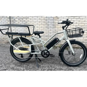 Close-up of the center-mounted color LCD display on the Revom ECargo bike, showing speed, battery life, and pedal assist levels.