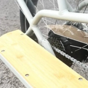 Detail view of the wooden running boards and footrests for rear passengers on the Revom ECargo bike.